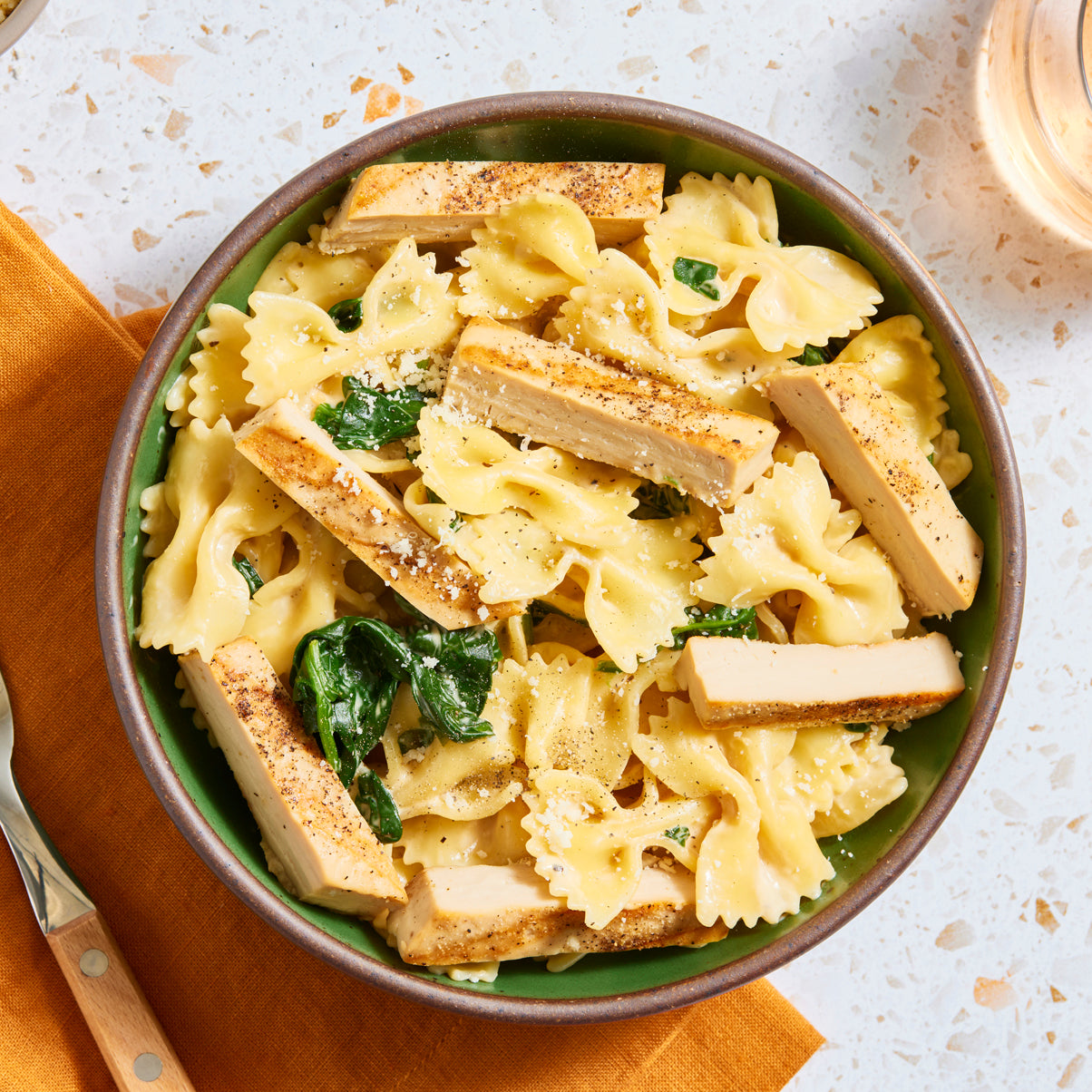 a bowl of pasta with sliced meati classic cut.